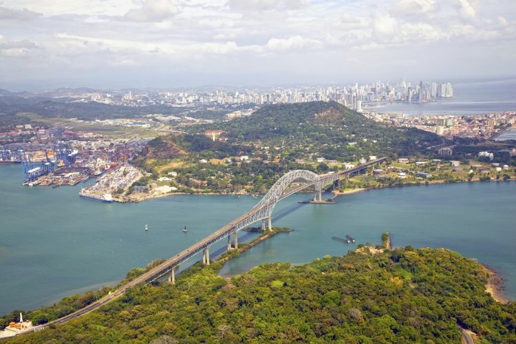 Aerial view of the Bridge of the Americas at the Pacific entrance to the Panama Canal with Panama City in the background. Snowbird Destination