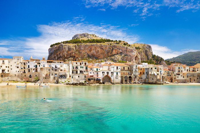 Medieval houses and La Rocca Hill, Cefalu, Sicily, Italy.