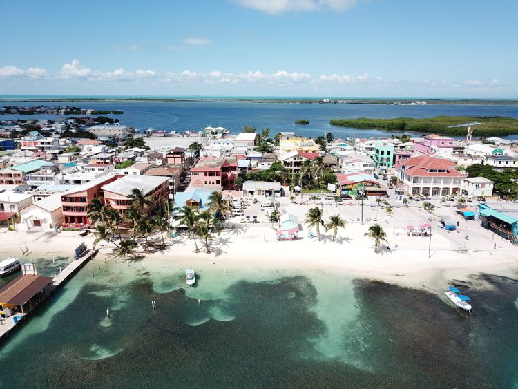 Areal image of houses and white sand beach in San Pedro Town, Belize