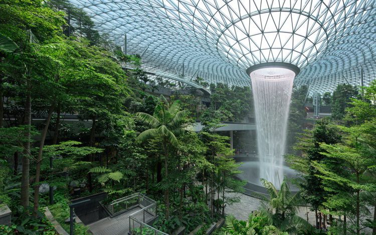 Jewel Changi Airport is a new terminal building under a glass dome, with indoor waterfall and tropical forest, shopping malls and dining, in Singapore