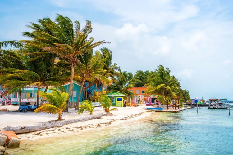 Orange, blue, green, and pink houses in Caye Caulker, Belize.