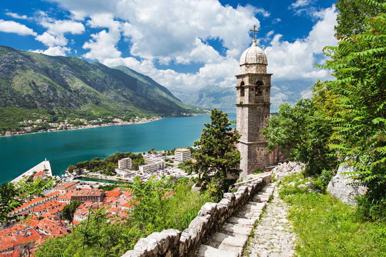View of an old church, sea, and houses in Kotor