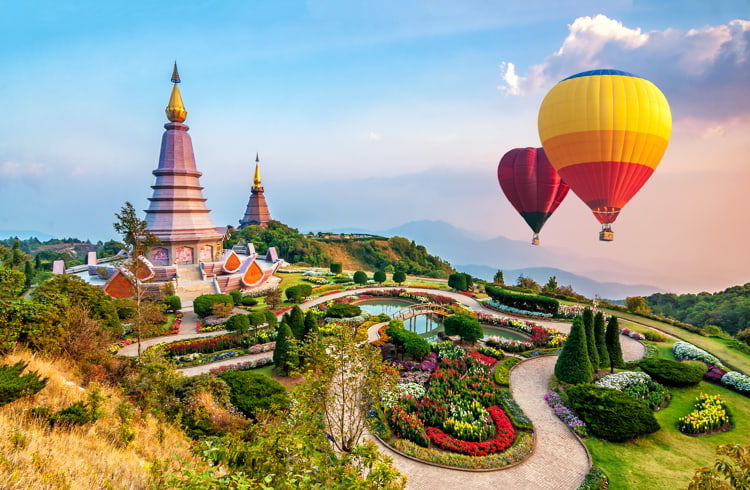 Colorful hot-air balloons flying over the Doi Inthanon National Park with sunset at Chiang Mai, Thailand.