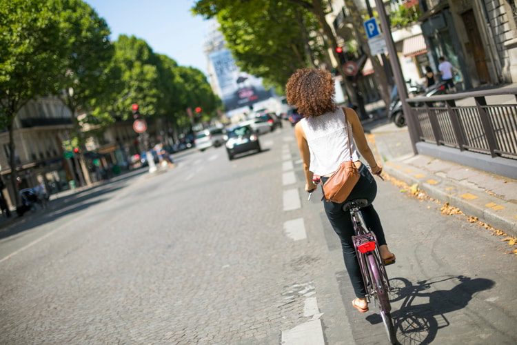 Young woman riding bike in Paris
