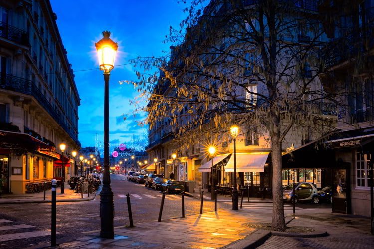 Paris beautiful street in the evening with lampposts