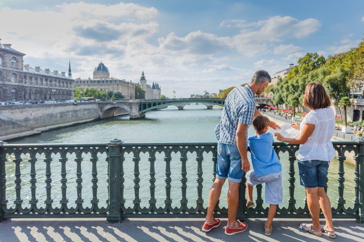 Happy family of three enjoying vacation in Paris, France