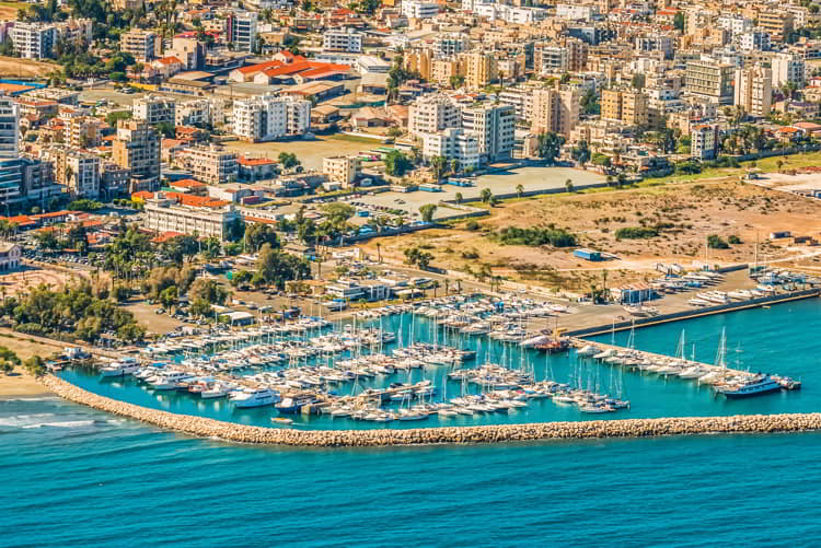 View from an aircraft of the coastline, beaches, seaport and the architecture of the city of Larnaca.