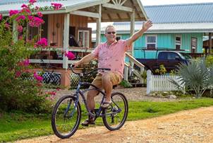 Senior man riding a bicycle in Carmelita Gardens