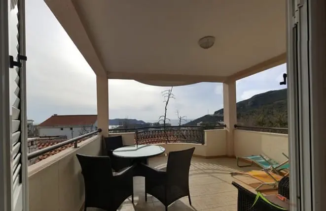 The balcony of an apartment for rent in Montenegro near the beach