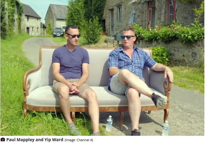 Paul Mappley and Yip Ward sitting on a couch on the village they bought