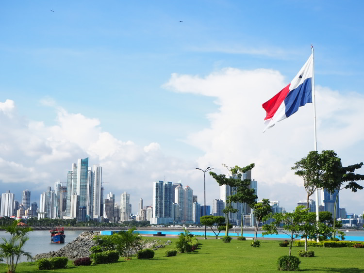 Panama City, Panama skyline with green grass and flag flying.