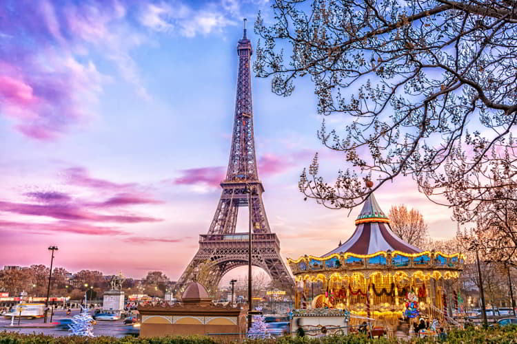 The Eiffel Tower and vintage carousel on a winter evening in Paris, France