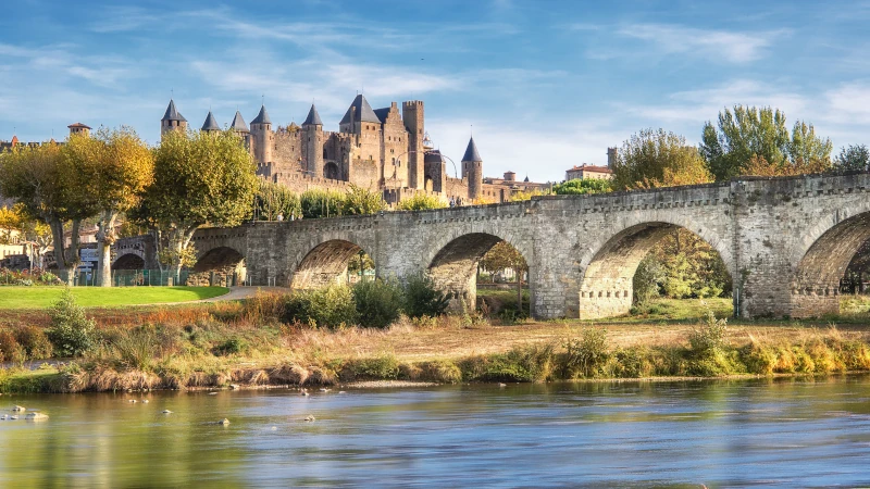 Carcassonne and the Le Pont Vieux bridge viewed from across the Aude river. Southern France