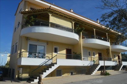 A yellow duplex house in Greece