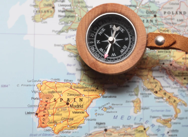 Compass on a map pointing at Spain