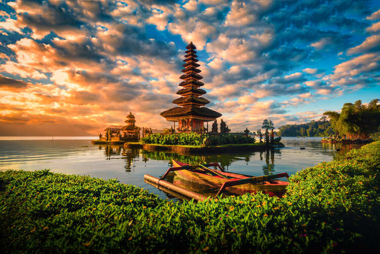 Pura Ulun Danu Bratan, Hindu temple with boat on Bratan lake landscape at sunrise in Bali, Indonesia.