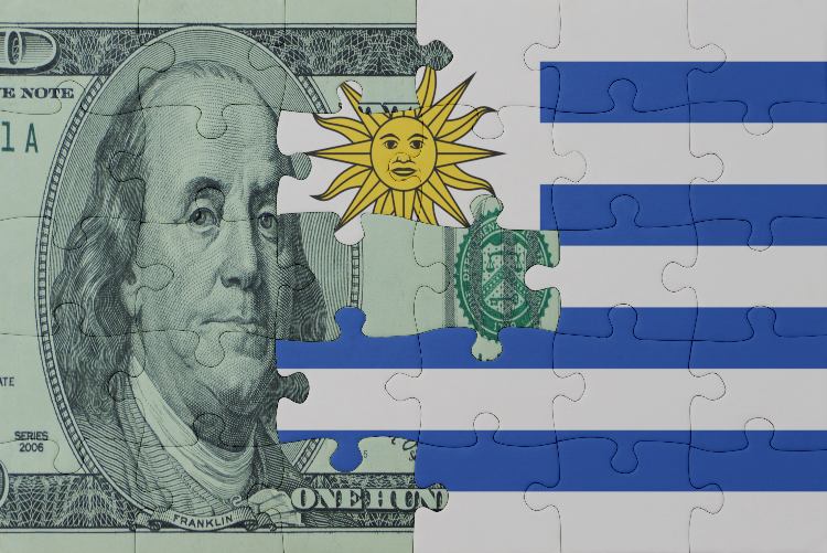 A hundred dollar bill and Uruguay's flag