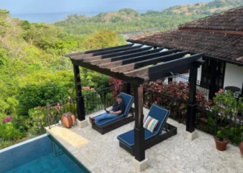 Person relaxing by a hotel pool