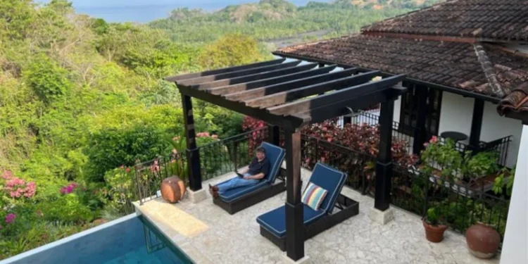 Person relaxing by a hotel pool