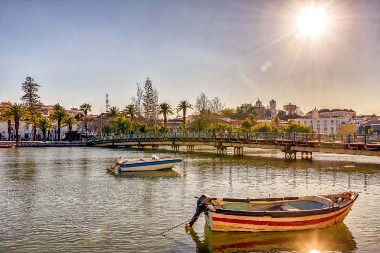 Colorful boats on Gilao river in picturesque Tavira, Portugal