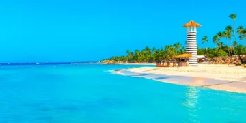 Panoramic view of the tropical beach with lighthouse in Dominican Republic. cost of living