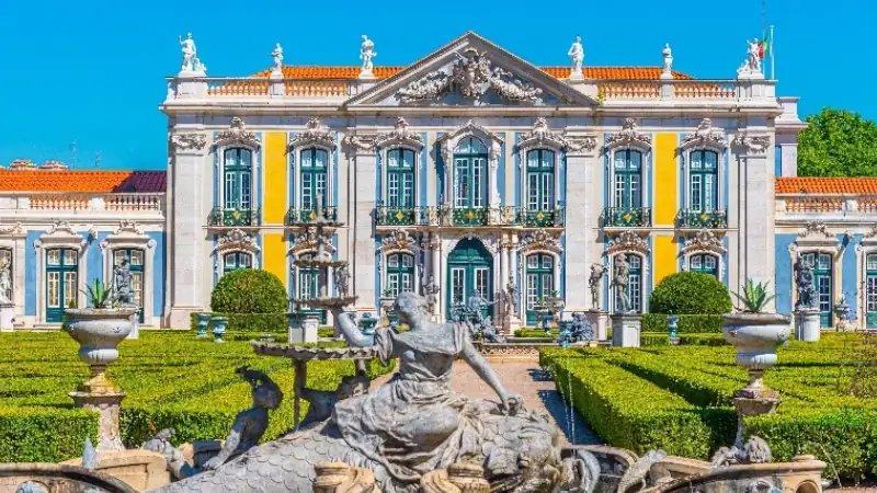 Elegant Queluz National Palace in Portugal, featuring ornate architecture, formal gardens, and fountains.