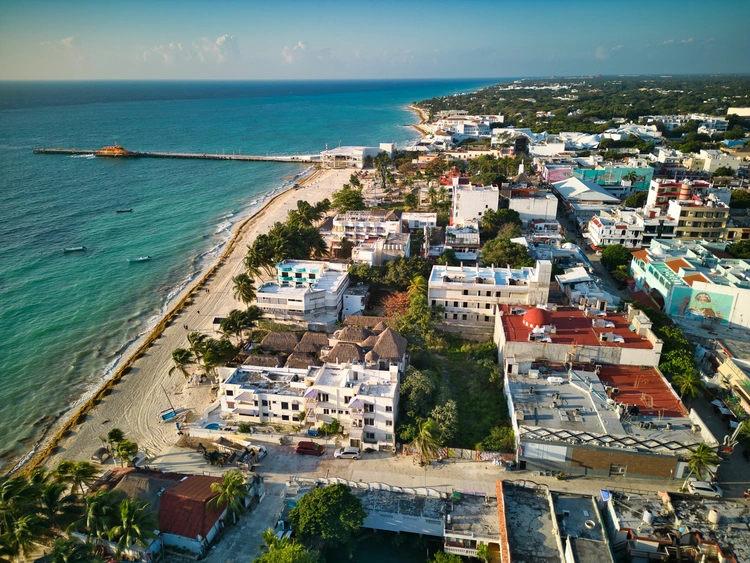 Aerial of Playa del Carmen town skyline surrounded by a sandy beach and the sea