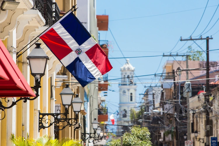 Arzobispo Merino street, santo domingo. Flag of the Dominican Republic on the wall of a building in the colonial zone