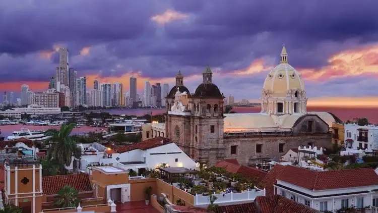 View from the walled city looking at the Church of St Peter Claver and the modern skyscrapers of Boca Grande in the background in Cartagena, Colombia.