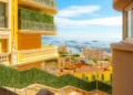 Benefits of overseas property showcased by luxury residential apartments, condos, and townhomes in the hills of Monte Carlo, Monaco, overlooking the Rock, Mediterranean Sea, and marina along the Riviera.
