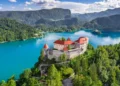 Bled, Slovenia - Aerial panoramic view of beautiful Bled Castle (Blejski Grad) with Lake Bled (Blejsko Jezero), the Church of the Assumption of Maria and Julian Alps at background on a summer day