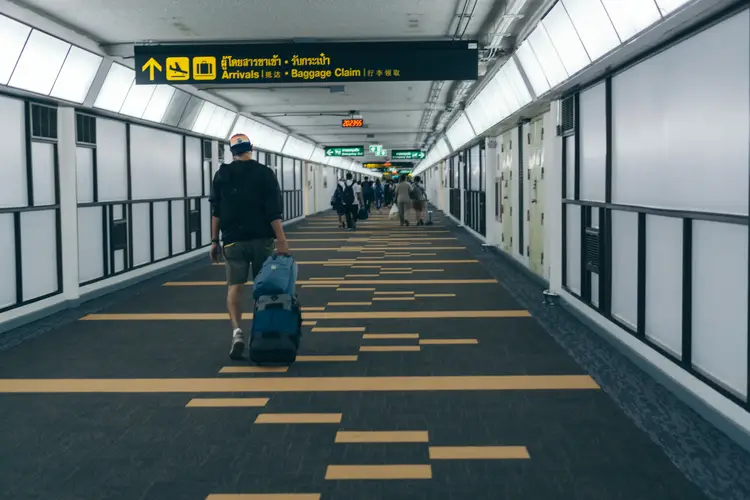 Tourists walking with luggage in Don Mueang Airport, in Thailand. infrastructure in thailand