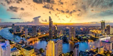 Panorama of Taksin Bridge over Chao Phraya River, Bangkok, Thailand at sunset.
