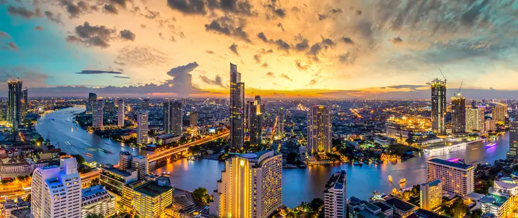 Panorama of Taksin Bridge over Chao Phraya River, Bangkok, Thailand at sunset.