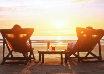 happy couple enjoy luxury sunset on the beach during summer vacations