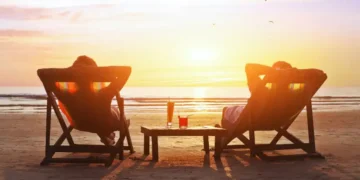 happy couple enjoy luxury sunset on the beach during summer vacations
