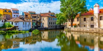 Old buildings in Viseu reflected on a local creek, Portugal