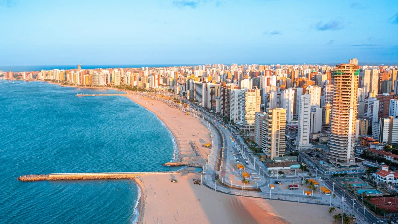 Drone sunset skyline of Fortaleza Brazil beachfront — cheap real estate overseas