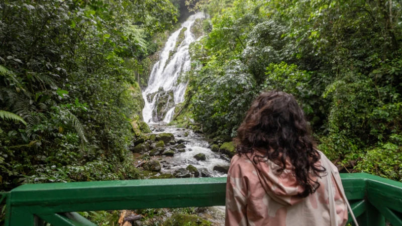 Tourist observing the Chorro el Macho waterfall in Valle de Anton, Panama