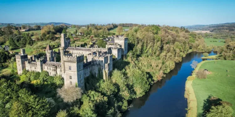 Aerial view of Lismore Castle, County Waterford, Ireland, on a tranquil spring day under a flawless blue sky