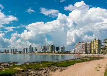 Tourist walking on Rambla (street) Claudio Wiliman towards a beach of Punta Del Este, Uruguay
