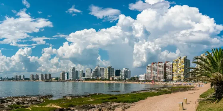 Tourist walking on Rambla (street) Claudio Wiliman towards a beach of Punta Del Este, Uruguay