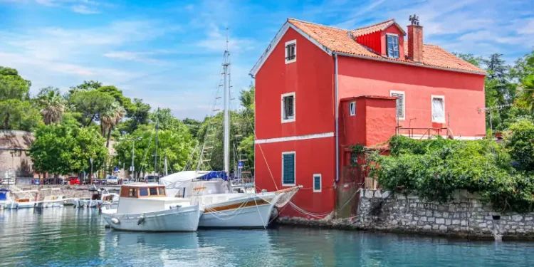 Fisherman's red house on the water. Croatia, Zadar.