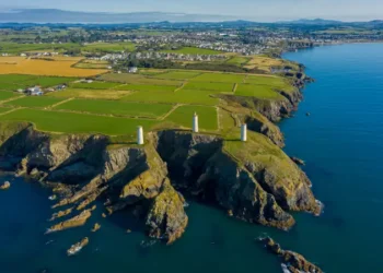 Aerial view, The Metal Man is a 3-metre tall cast-metal figure of a sailor pointing seawards. According to local lore, he is said to warn seafarers away from dangerous shallow waters.