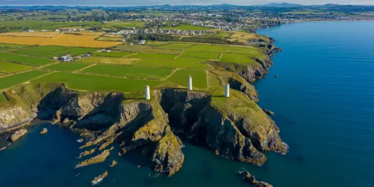 Aerial view, The Metal Man is a 3-metre tall cast-metal figure of a sailor pointing seawards. According to local lore, he is said to warn seafarers away from dangerous shallow waters.