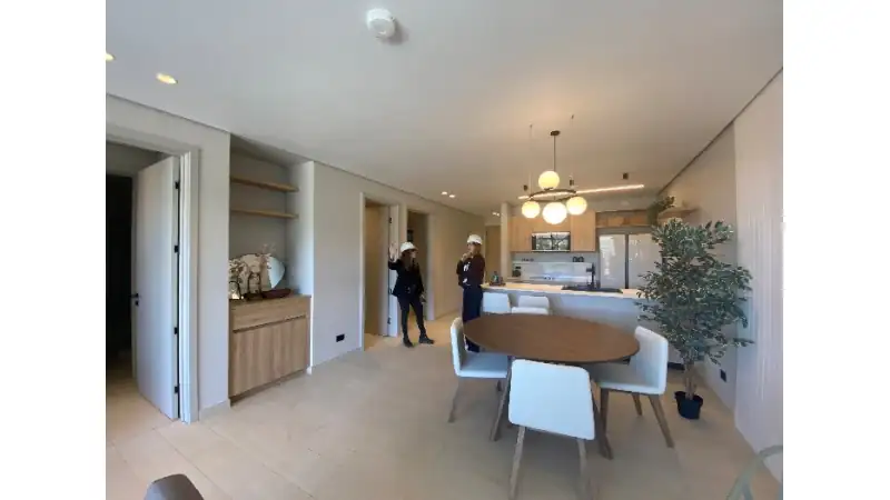 Bright, modern interior with an open kitchen and dining area overlooking the Boquete landscape.
