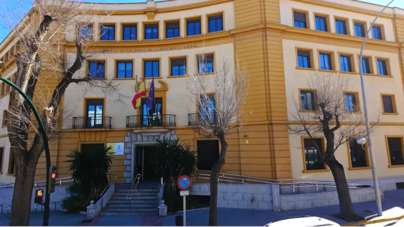 Cadiz Social Security office building displaying Spanish and Andalusian flags - CADIZ, SPAIN