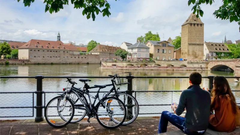 A young couple sitting on the embankment of the river ill in Strasbourg France