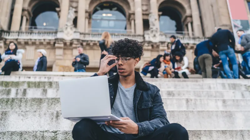male digital nomad working remotely near Montjuic building in Barcelona