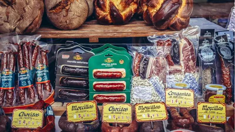 Food products for sale at a storefront in the old part of Oviedo city